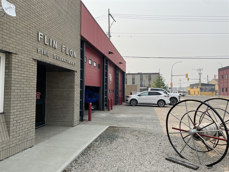 The Flin Flon Fire Hall, with a smokey sky behind it.
