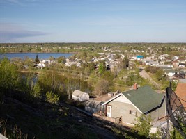 An image overlooks houses in Flin Flon, Ross Lake to the left.