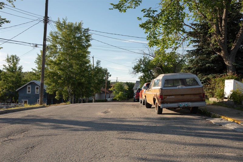 A street with a car on the right frame.