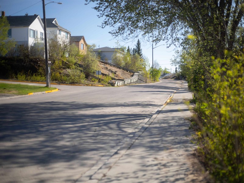 A residential street in Flin Flon with homes beside the road.